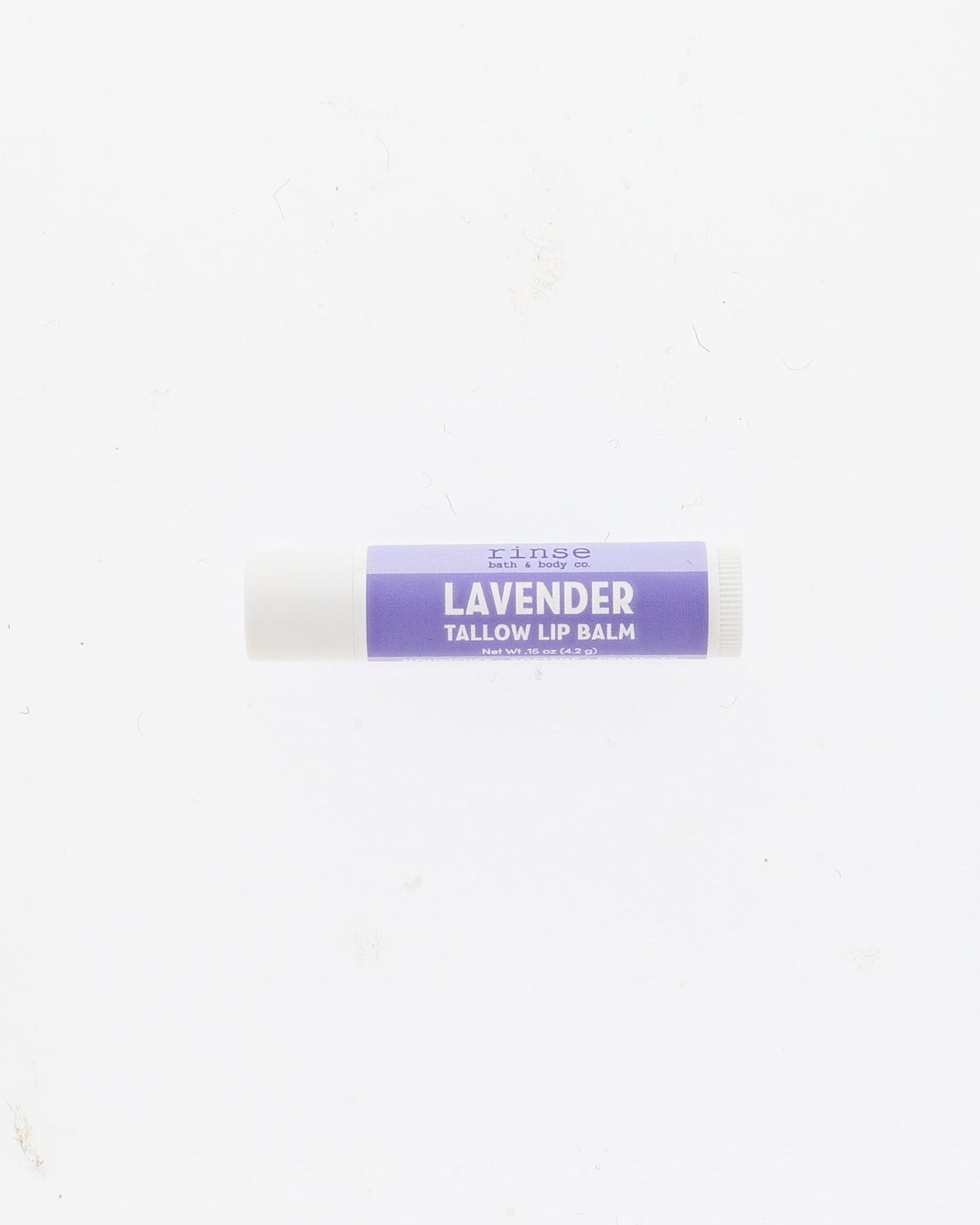 A single tube of lavender tallow lip balm with a purple label and white cap, centered on a plain white background.