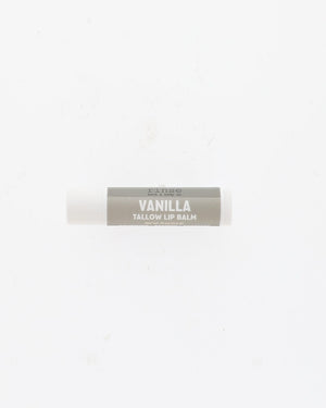Vanilla Tallow Lip Balm tube with grey label and white cap lying on a plain white background