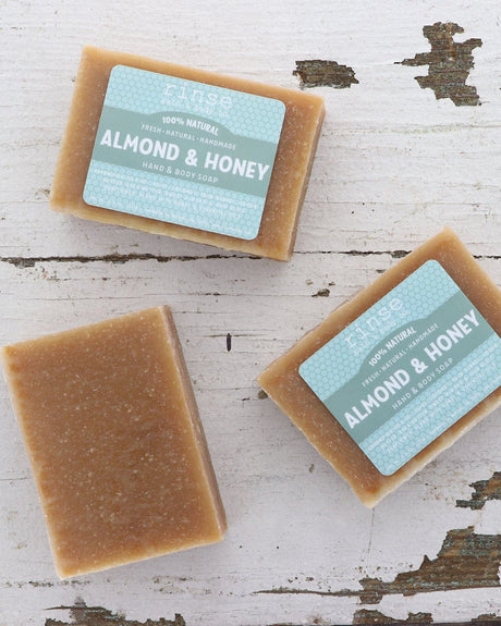 Almond & Honey bar soap styled with whole almonds and honey — the warm bakery-sweet scent the bar is named for. Rinse Bath & Body Co.