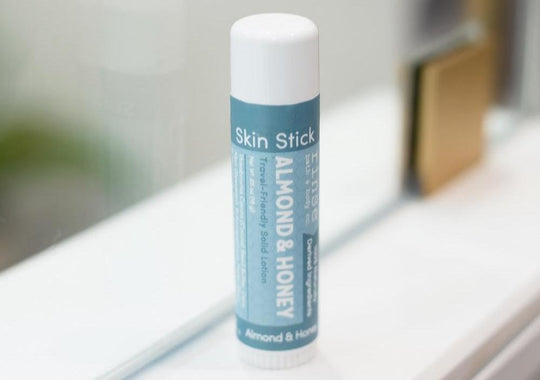 almond honey skin stick sitting on window sill