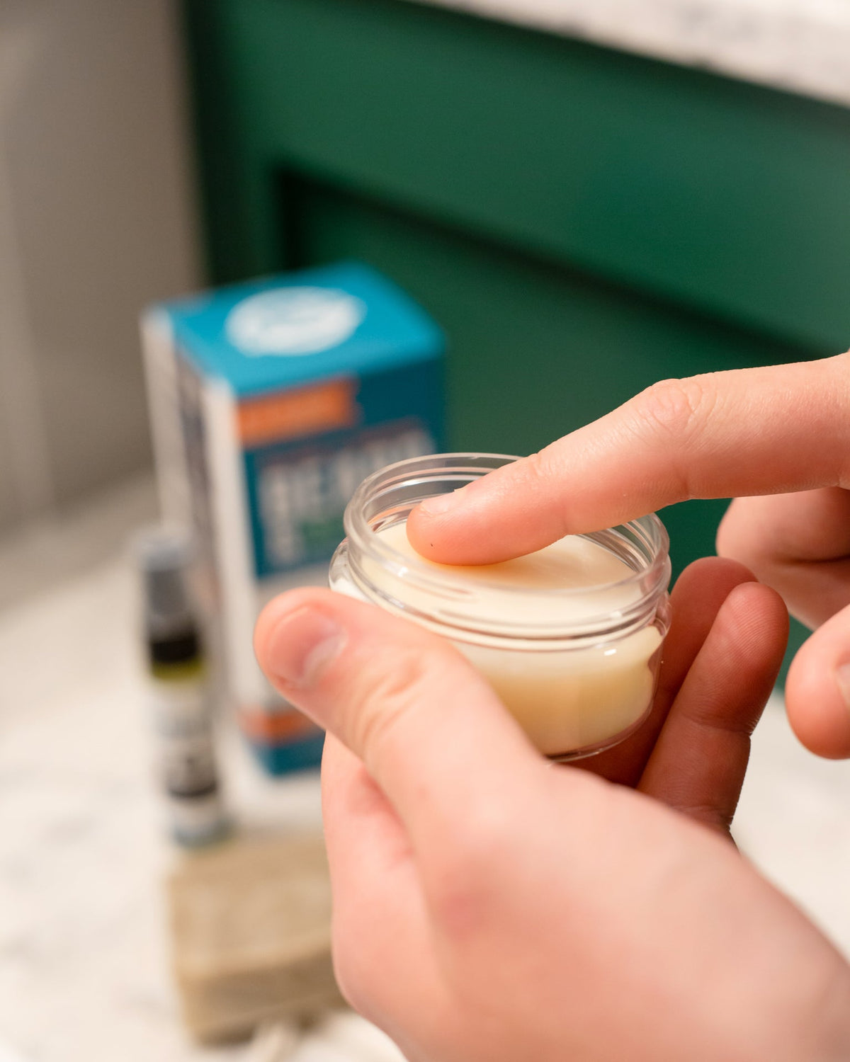 A hand working Rinse Conditioning Beard Balm into a full beard — cocoa butter and jojoba softening coarse facial hair. Rinse Bath & Body Co.