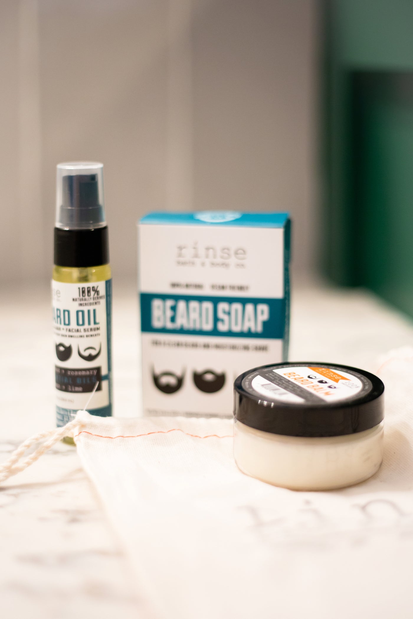 Rinse beard oil, beard soap and balm arranged on marble - Rinse Bath & Body