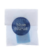 Blue Citrus soap slice in translucent wrap — dark blue circle sticker on clean bright white