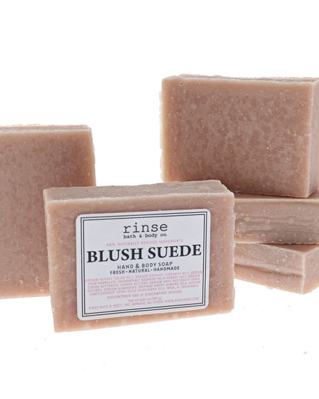 Five Blush Suede soap bars stack behind a labeled face — dusty rose speckles on clean bright white
