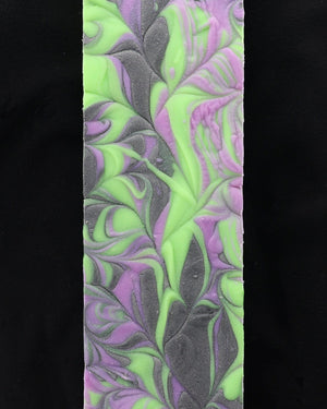 Boo To You soap loaf showing neon green and purple marble — charcoal base popping on matte black