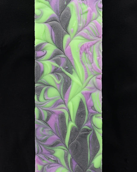 Boo To You bar soap from the side, showing the poured swirl running through the bar. Rinse Bath & Body Co.