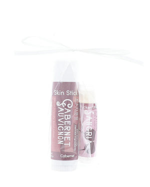 Cabernet Skin Stick and Sangria Pucker Stick tied in a clear gift bag with a white ribbon bow