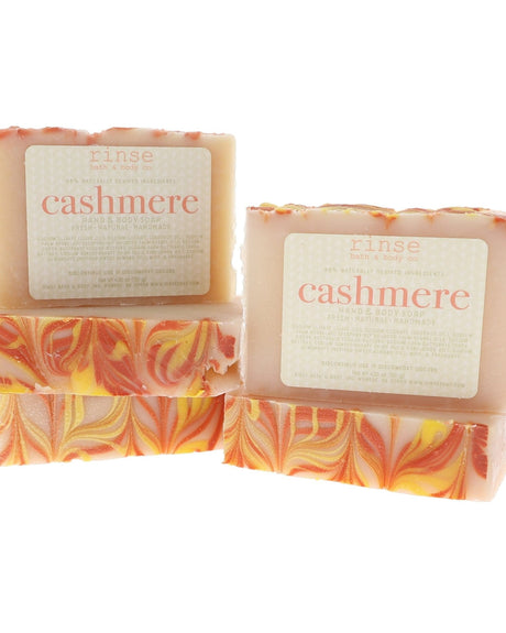 Two Cashmere bars display cream tops and fiery orange swirls — clean bright white studio