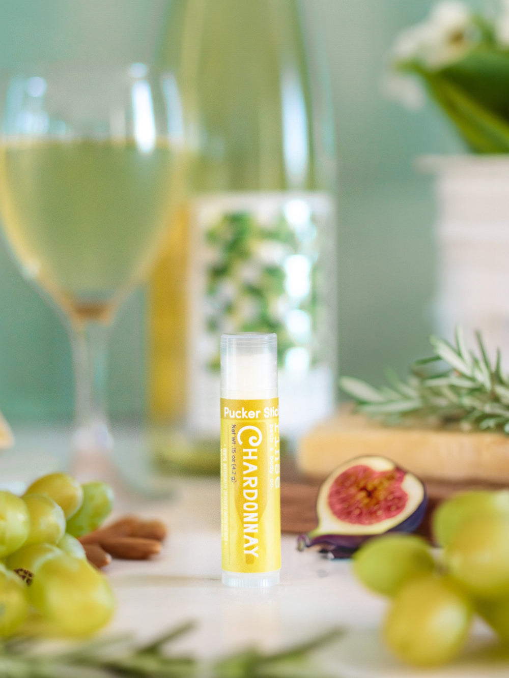 Chardonnay Pucker Stick standing before white wine grapes almonds and cheese — breezy teal picnic light