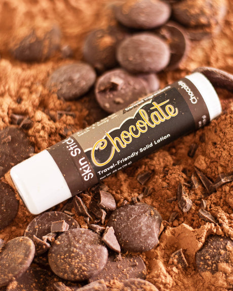 Chocolate solid lotion stick — real cocoa in a twist-up bar for dry hands and elbows. Rinse Bath & Body Co.