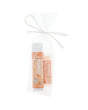 Coconut Mango Skin Stick and Mango Pucker Stick tied in a sheer white gift bag with a white ribbon bow