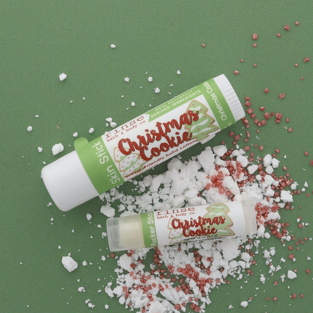 Christmas Cookie Skin Stick and Pucker Stick lifestyle on forest green — sugar crystals and bakery sprinkles