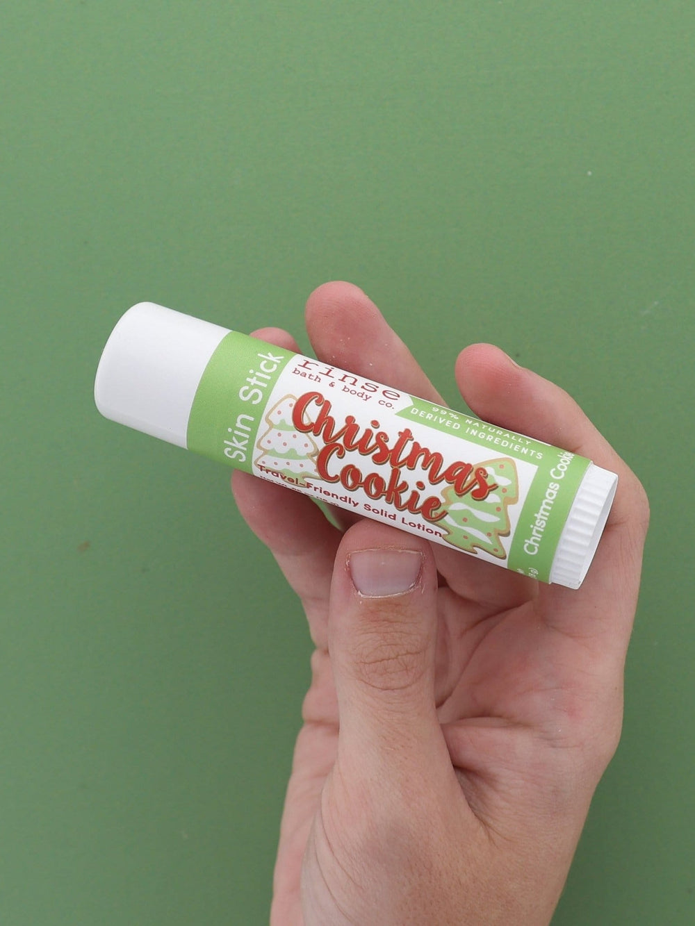 Christmas Cookie Skin Stick solid lotion stylized — sugar-cookie twist-up moisture bar on bright white
