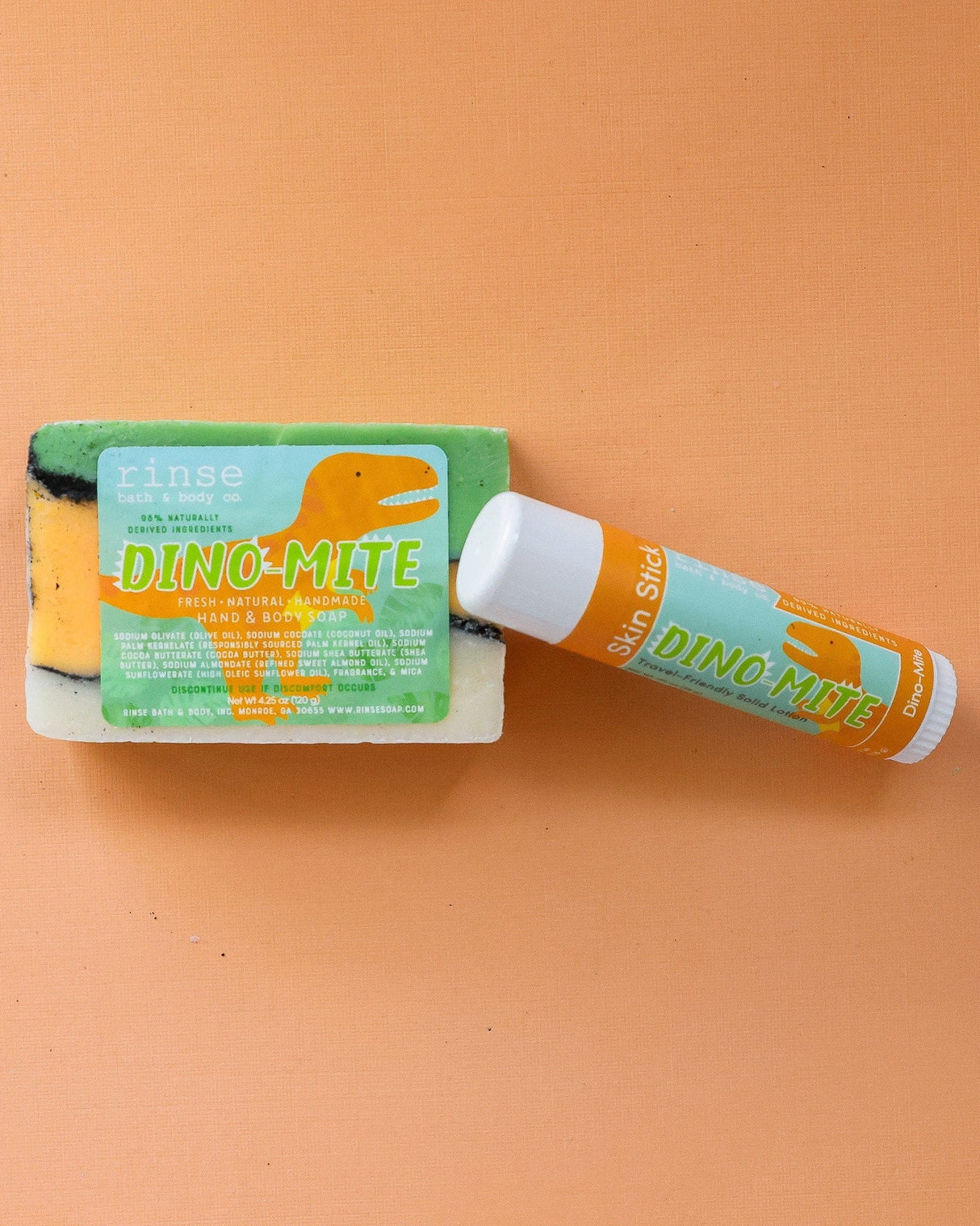 Dino-Mite solid lotion stick — a playful twist-up moisture bar built for small hands. Rinse Bath & Body Co.