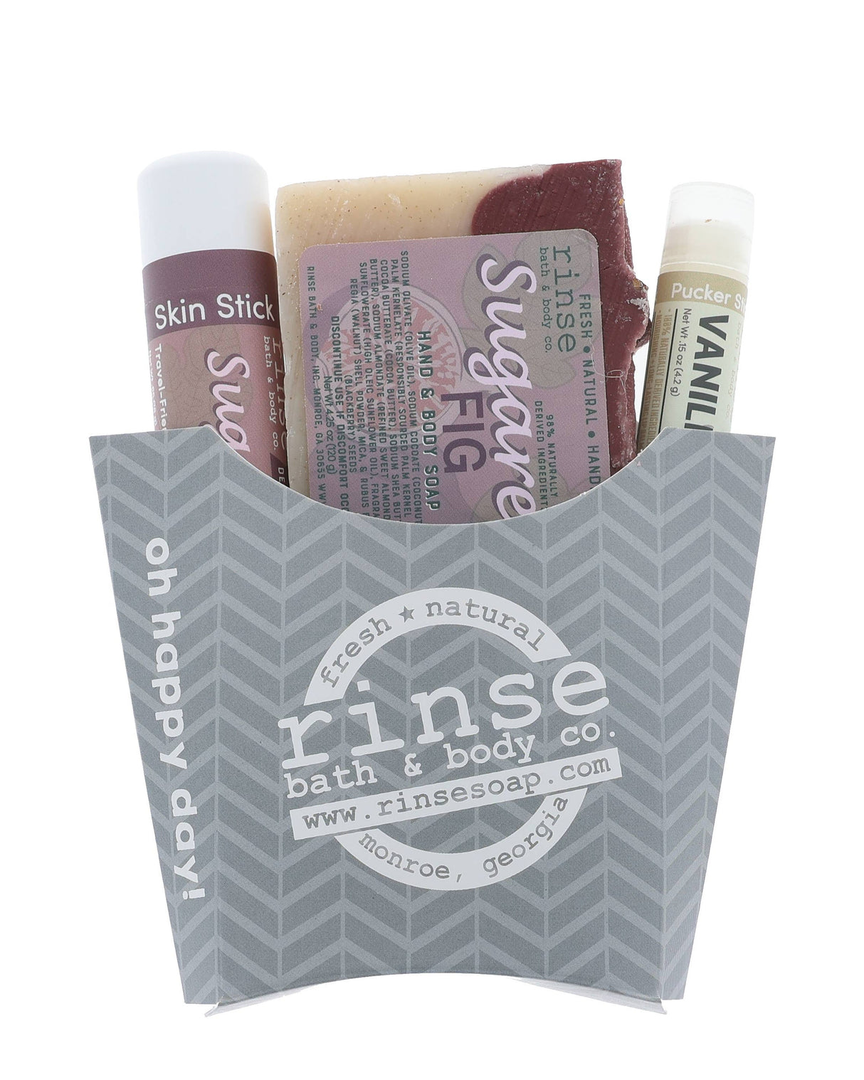 The Sugared Fig fry-box gift set in its grey chevron carton — Sugared Fig bar soap, Sugared Fig solid lotion skin stick and a Vanilla lip balm, ready to hand over. Rinse Bath & Body Co.