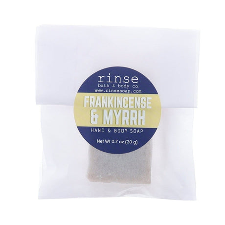 Frankincense Myrrh soap slice in translucent glassine — blue-yellow circle sticker on clean bright white
