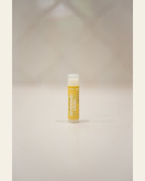 Ginger Lemongrass Pucker Stick standing upright — bold yellow label and clear cap on soft cream background