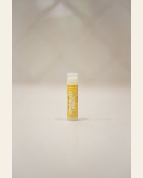 Ginger Lemongrass Pucker Stick standing upright — bold yellow label and clear cap on soft cream background