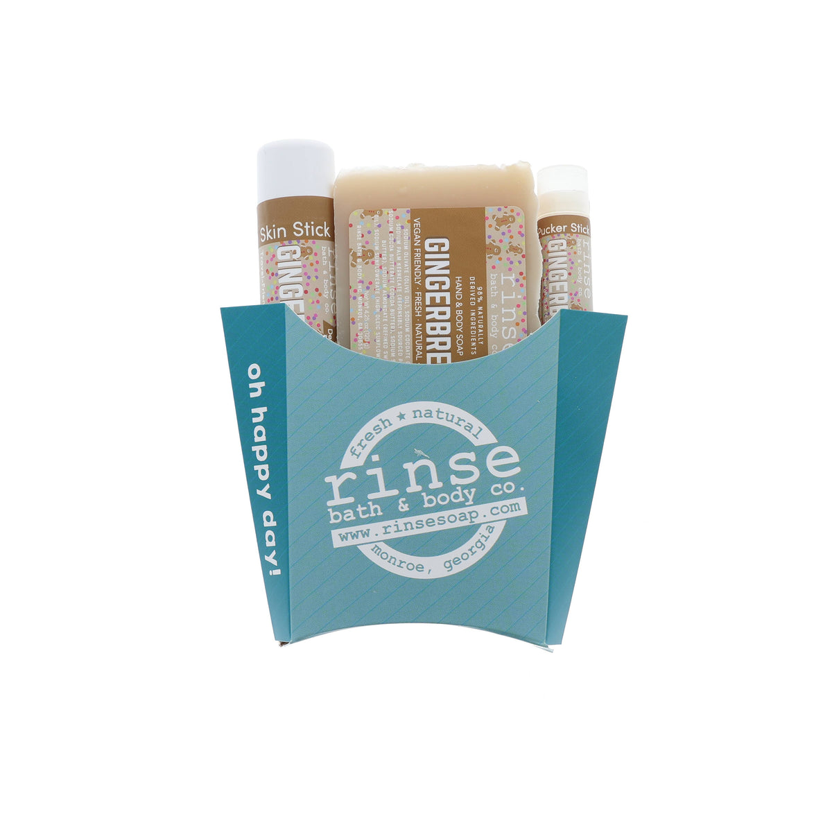 Gingerbread holiday trio nestled in a teal oh-happy-day fry box — creamy soap and travel sticks in studio light