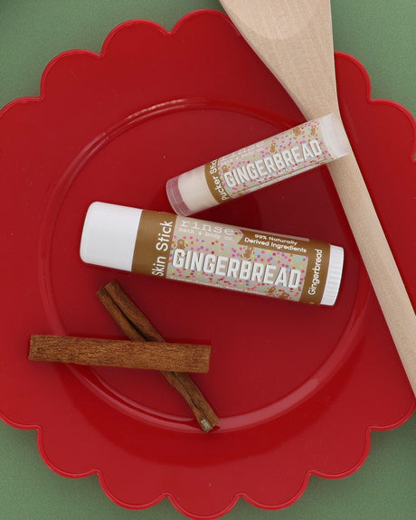 Gingerbread Skin Stick and Gingerbread Pucker Stick on a red scalloped plate with cinnamon sticks and a wooden spoon
