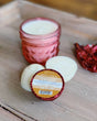 A Gingerbread Tub Truffle in gingerbread-brown foil — warm ginger and molasses with cocoa butter, for a winter bath. Rinse Bath & Body Co.