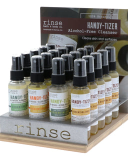 Stocks a wood-and-metal fixture with labeled Handy-Tizer hand cleanser sprays — filled retail display.
