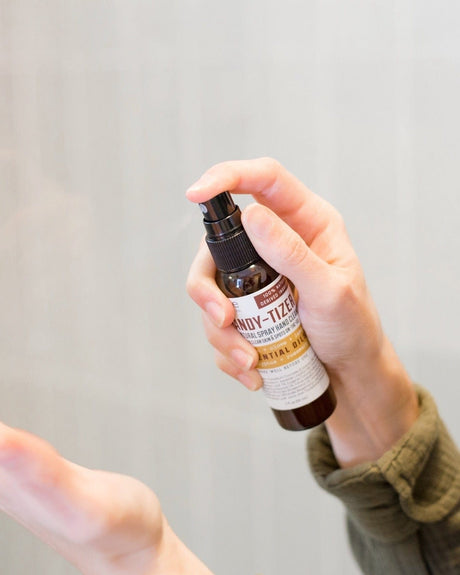 Thievery Handy-Tizer spray bottle — a 62% alcohol hand spray carrying the warm clove-and-cinnamon four-thieves blend. Rinse Bath & Body Co.