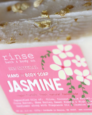 Close-up Jasmine soap with dried botanical top — bright pink flower label catching studio light