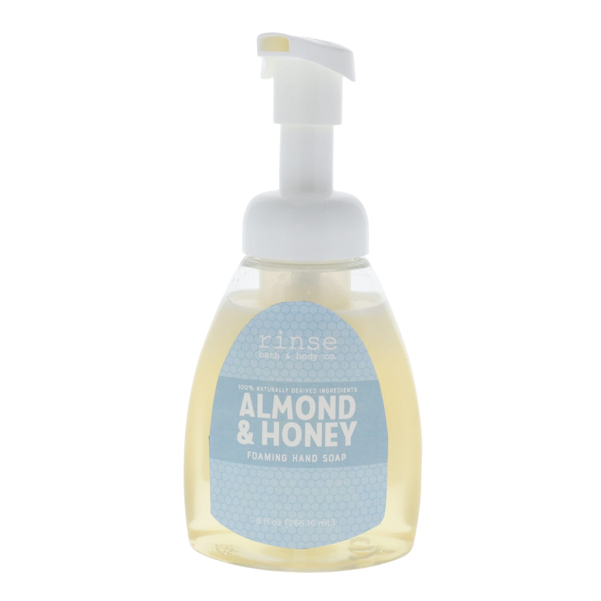 Almond & Honey Foaming Hand Soap standing on bright white — golden liquid and dusty-blue honeycomb label in clean studio light
