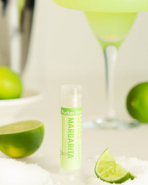 Margarita lip balm styled with lime — fresh-squeezed lime and salt in a twist-up balm. Rinse Bath & Body Co.