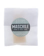 Maschile soap slice in translucent wrap — grey-blue circle sticker on clean bright white