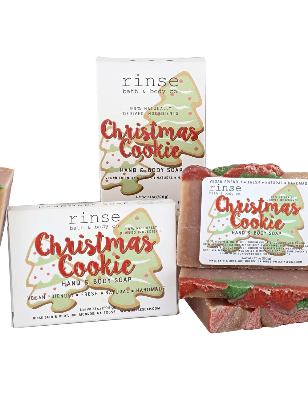 Christmas Cookie mini soaps stacked with tree-cookie cartons — tan bars topped with red and green frosting swirls on white