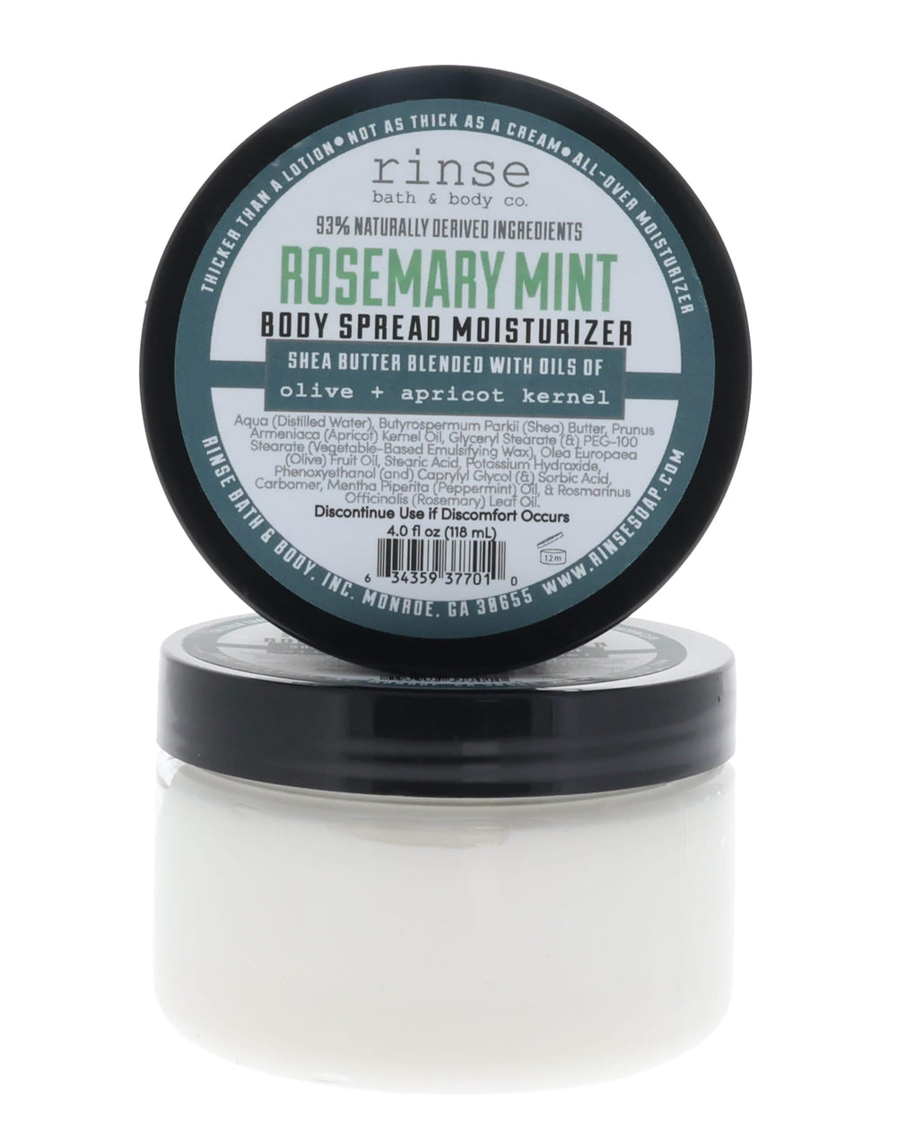 Rosemary Mint Body Spread jar with black lid propped behind — green-bordered label in bright white studio light