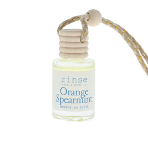 Small bottle of 'Orange Spearmint' perfume with a rope on a white background
