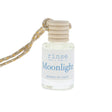 Small bottle labeled 'Moonlight' with a string on a white background