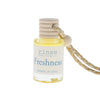 Small bottle labeled 'Freshness' with a string on a white background