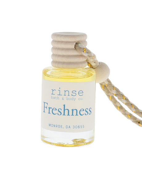 Small bottle labeled 'Freshness' with a string on a white background