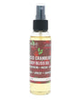 Spiced Cranberry Body Bliss Oil standing on bright white — pale yellow oil and wood-grain cranberry label