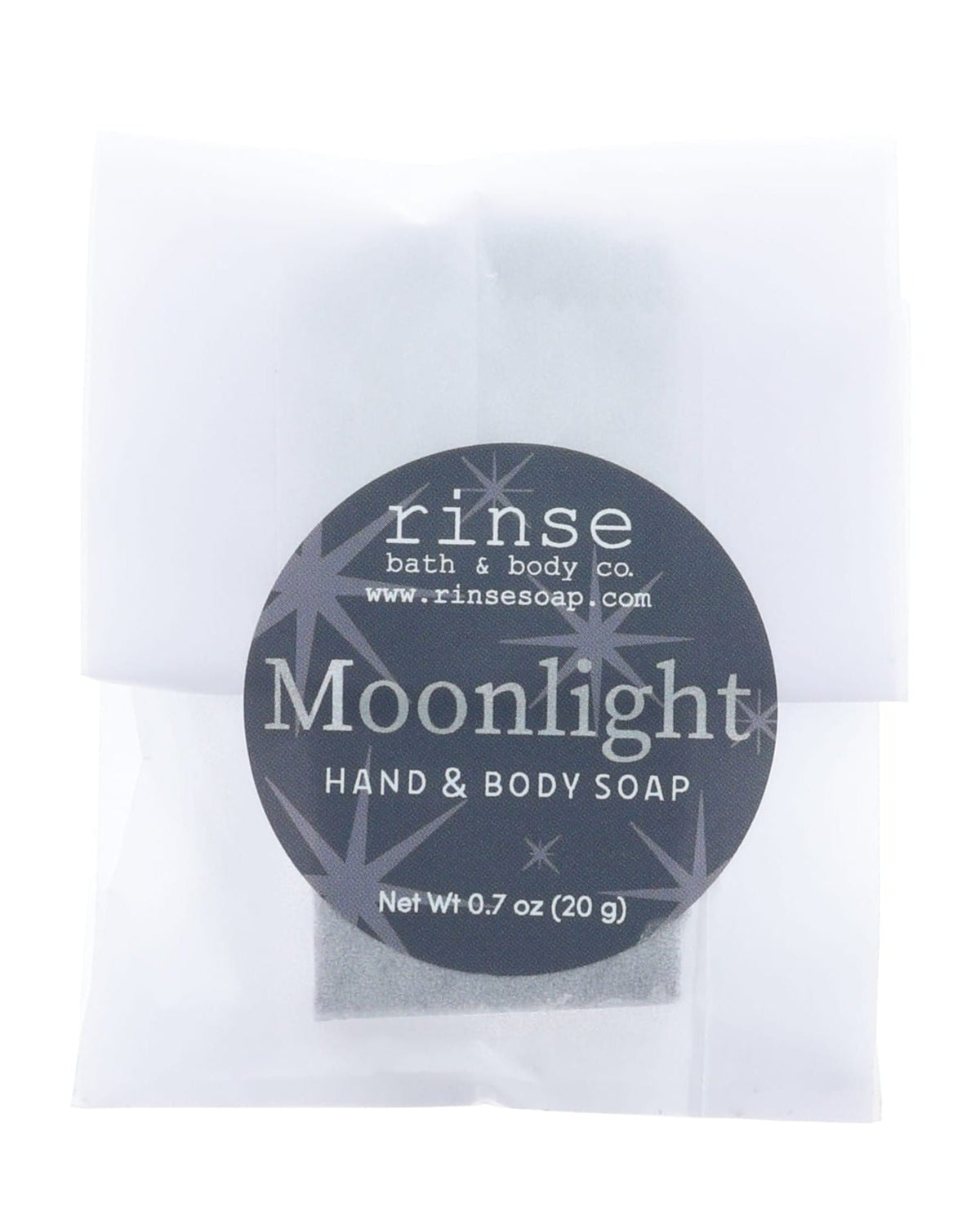 Moonlight soap slice in frosted glassine — black starry circle sticker on clean bright white