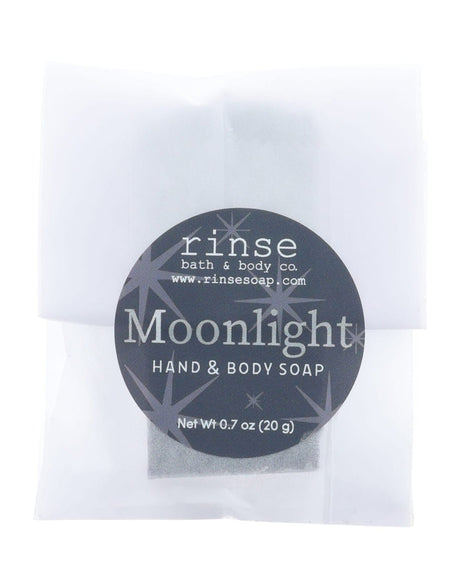 Moonlight soap slice in frosted glassine — black starry circle sticker on clean bright white