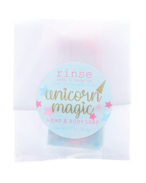 Unicorn Magic soap slice in translucent wrap — blue starry circle sticker on clean bright white