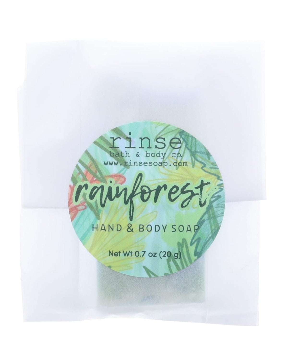 Rainforest soap slice in translucent glassine — green tropical circle sticker on clean bright white
