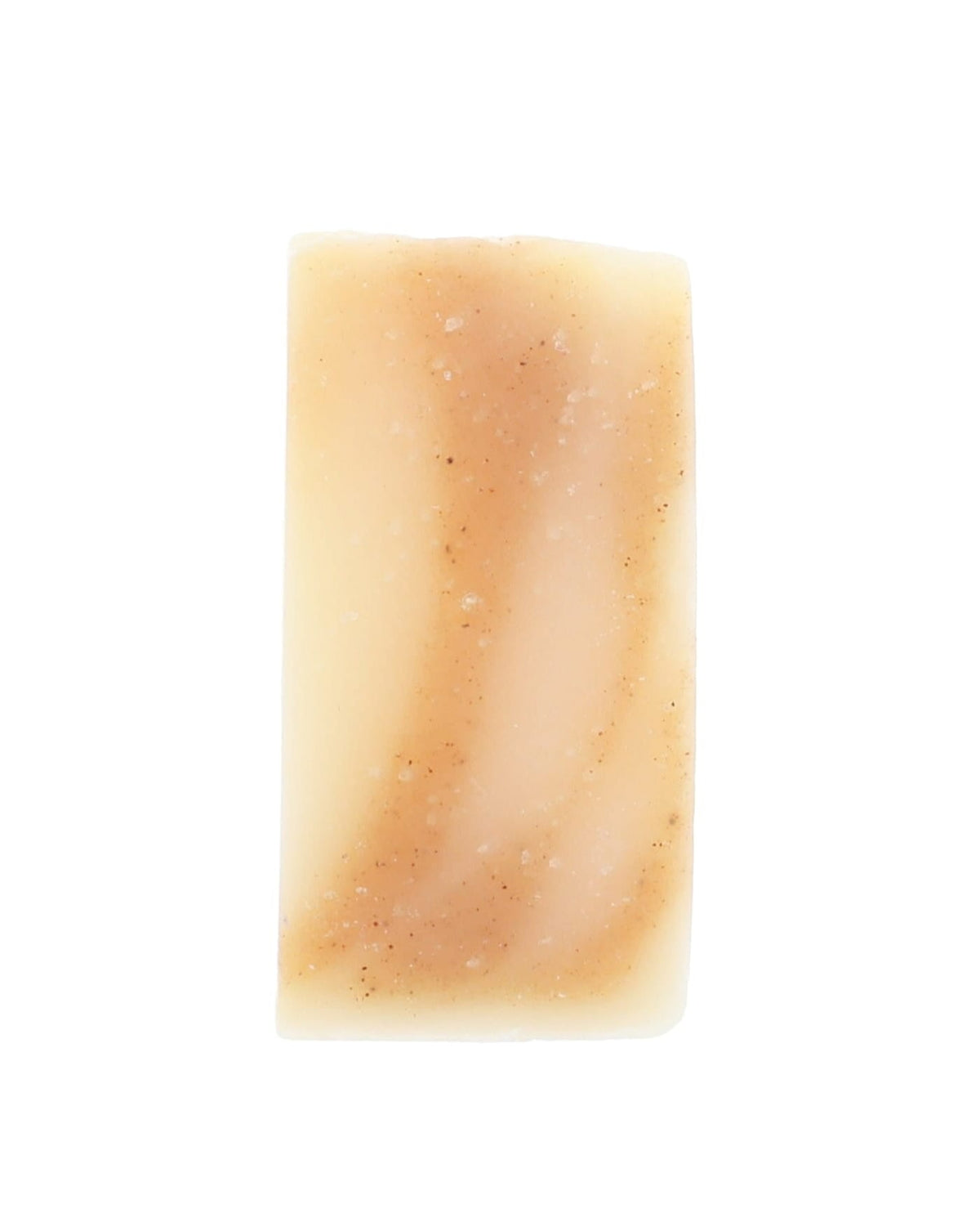 Bare Golden Glow soap slice stands upright — ivory bar with speckled tan swirls on stark white
