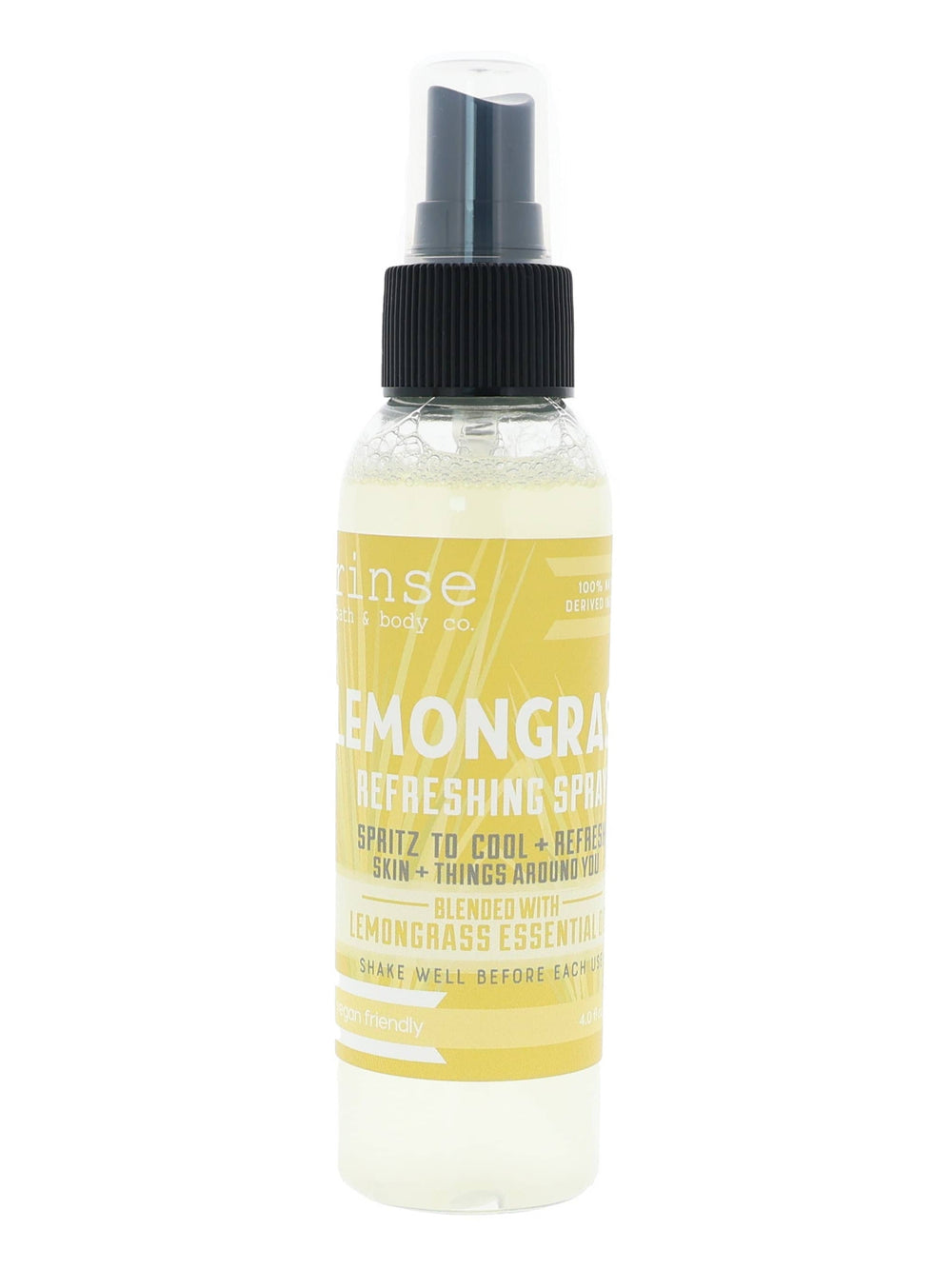 Lemongrass Refreshing Spray standing on bright white — yellow label and pale citrus mist bottle in studio light