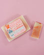 Nutcracker bar and thin slice on dusty pink — cream terracotta marble under soft flat-lay light
