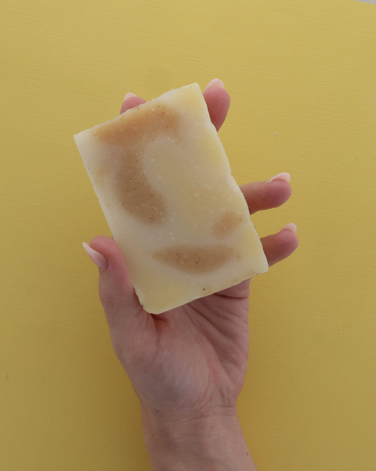 Rinse handmade bar soap styled on a wooden surface