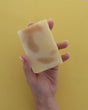 Rinse handmade bar soap styled on a wooden surface