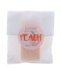 Peach soap slice in translucent glassine — peach circle sticker on clean bright white