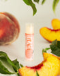 Peach lip balm — ripe summer peach in a cocoa-butter balm that isn't waxy. Rinse Bath & Body Co.