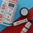 The Pedi-to-Go set laid out on red and blue card — Peppofoot Stick, Peppofoot Spray and Peppofoot Polish with their printed sleeve, the full foot-care routine in one box. Rinse Bath & Body Co.